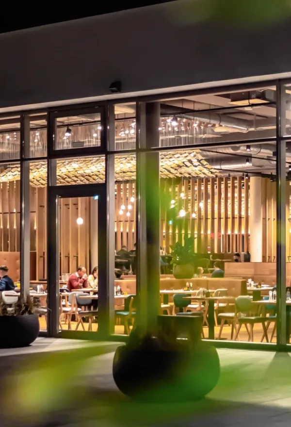 Ein stylishes Restaurant mit Glasfassade in stimmungsvollem Licht